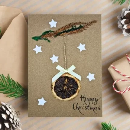 Handmade-Christmas-card-with-dried-orange-slice-white-stars-and-bow