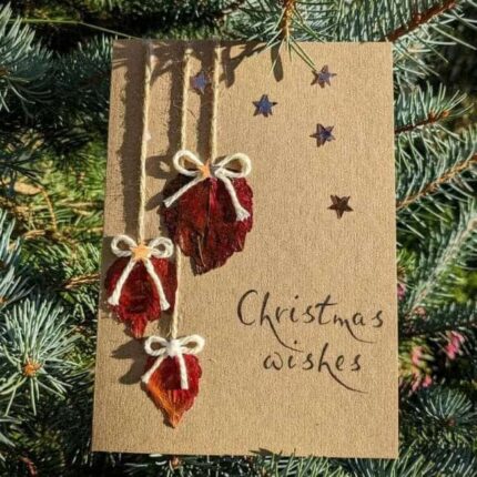 Handmade-Christmas-Card-with-Dried-Leaves-and-Bows-outside