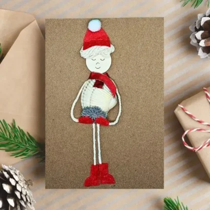 Hamemade-Christmas-card-with-snowboy-made-of-seashell